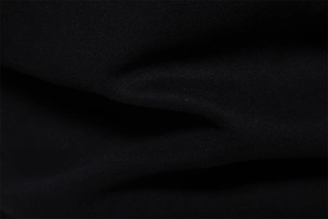 Macro texture view of the black knitted cotton fabric showing dense weaving quality