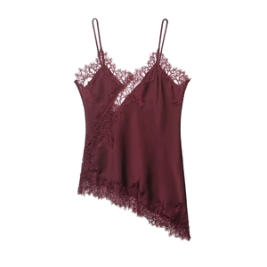 Detail of wine red silk camisole featuring delicate lace patchwork and asymmetric hemline