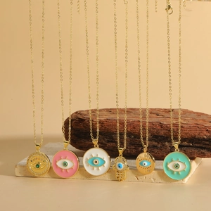 Detail of Hamsa Hand and Evil Eye necklaces with colorful enamel and zircon stones