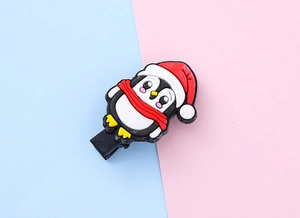 Close-up of a cute cartoon penguin hair clip with soft PVC texture and metal clip