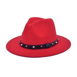 Detail of red wool felt fedora featuring black leather band with silver metal studs