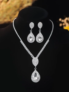 Close-up of luxury bridal jewelry set with sparkling rhinestones and teardrop crystals