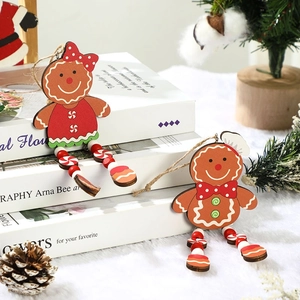 Wooden gingerbread couple Christmas tree ornaments with festive red outfits and bead legs