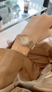 Close-up of elegant ladies' quartz watch with diamond accents and gold bracelet set