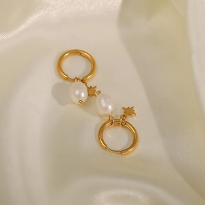 Detail of 18k gold plated stainless steel hoops with star charms and freshwater pearls