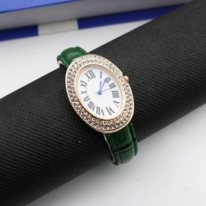 Detail of oval diamond bezel watch with green crocodile strap and Roman numerals