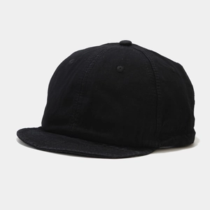 Detail of black washed cotton short brim baseball cap with six-panel soft top design