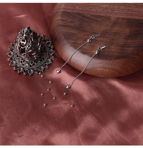 Detail of S925 sterling silver heart earrings on dark silk with luxury props