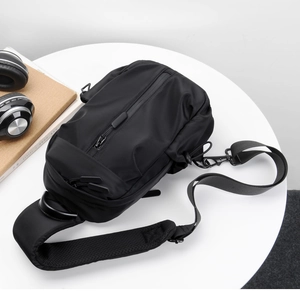 Detail of waterproof nylon chest bag featuring multi-layer zippers and breathable mesh back