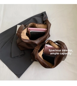 Macro view of spacious dark brown leather tote interior holding tablet and phone