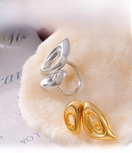 Macro shot of silver and gold hollow pig nose rings with PVD electroplating detail