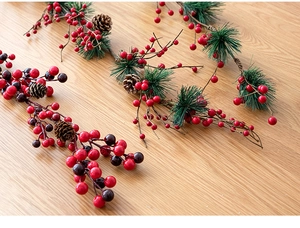 Detailed Christmas branches with red berries, green pine needles and natural pine cones