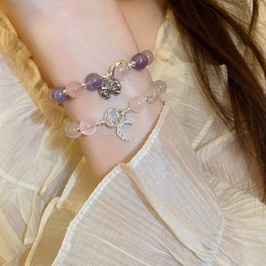 Chic beaded bracelet set with opal, butterfly charm, and moon pendant on wrist
