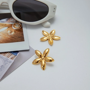 Detailed view of gold stainless steel flower earrings with a polished finish and chic look