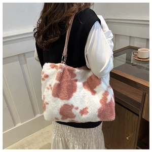 Close-up of plush tote bag with pink and white marble pattern on a female model