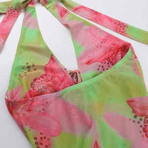Detailed macro view of halter neck straps and floral print on lightweight mesh summer dress
