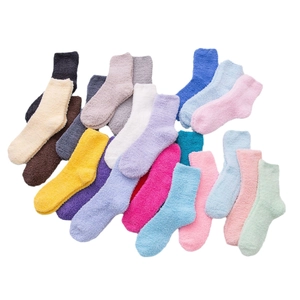 Assorted fluffy coral fleece slipper socks in vibrant candy colors on a white background