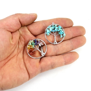 Macro detail of handmade Tree of Life pendants with natural turquoise and multicolor stones