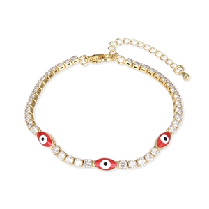 Gold evil eye bracelet with red enamel charms and sparkling cubic zirconia stones