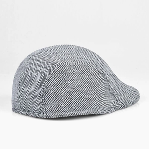 Detail of grey herringbone pattern on a retro style flat cap for men with quality stitching
