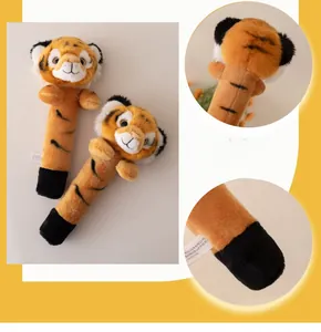 Detail of plush tiger hand rattles for babies featuring soft fabric and stitched details