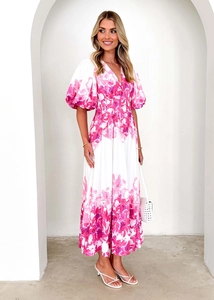 Close-up of V-neck floral puff sleeve dress with elegant pink patterns on white fabric