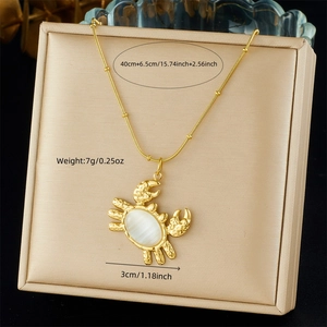 Detail of gold-plated crab pendant with oval white gemstone and necklace measurements