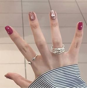 Silver multi-layer rope ring and spherical open ring set worn on finger with nail art