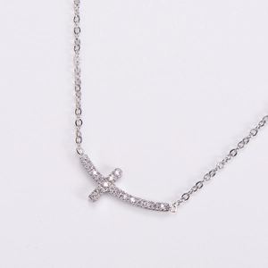 Silver side cross necklace with white rhinestones on a minimalist dainty chain