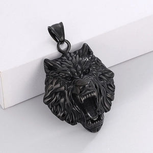 Macro close-up of a roaring wolf head pendant in polished black steel with intricate carvings