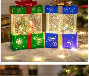 Christmas water globe gift set with Santa and snowman scenes in a snow-covered festive setup