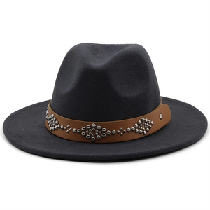 Detailed close-up of dark grey wool fedora featuring a brown leather studded belt trim