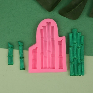 Detailed view of pink bamboo silicone mold with green leaf fondant cake decorations