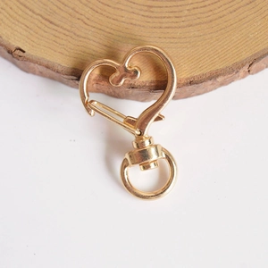 Close-up of heart-shaped gold alloy swivel clasp for keychain and bag accessory