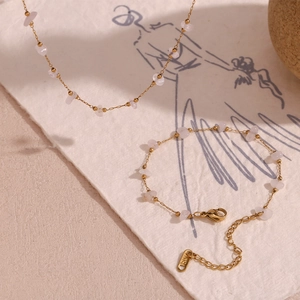 Detail of 18K gold-plated necklace and bracelet set with pink quartz stones