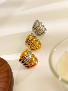 Detailed view of polished croissant rings in gold, silver, and two-tone finishes