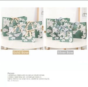 Detailed view of green floral gift bags with elegant bow handles in various sizes