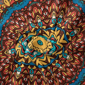 Detailed close-up of vibrant mandala tapestry showing silk-like texture and patterns