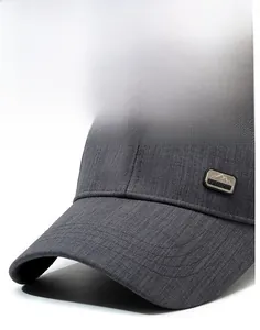 Detail view of dark grey baseball cap showing high-density twill fabric and fashion metal logo