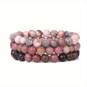 Set of three 8mm natural tiger eye and turquoise gemstone bead bracelets on white background