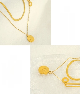 Detail view of gold double-layer stainless steel heart necklace with snake chain texture