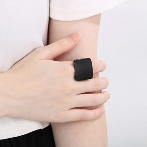 Close-up of a matte black square titanium ring on a finger with a modern geometric look