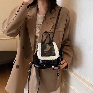 Mini PU leather backpack with white faux shearling trim and drawstring flap closure