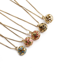 Close-up of golden necklaces with star-shaped hollow pendants in five colorful enamels