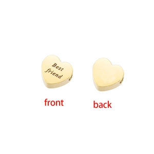 Detailed macro view of heart-shaped gold stainless steel beads with Best friend engraving