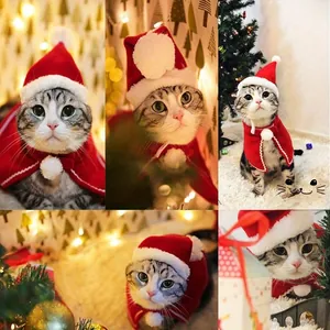 Detail of red plush pet Christmas hat and cape set with soft pompom decorations