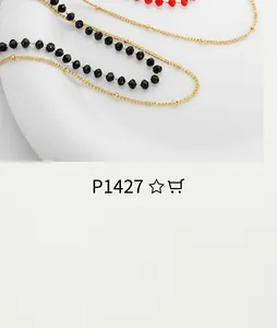 Macro shot of layered gold bead and black beaded chains with elegant metal clasp