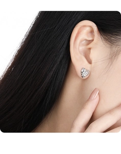 Macro shot of a sparkling heart-shaped S925 silver stud earring with clear crystals