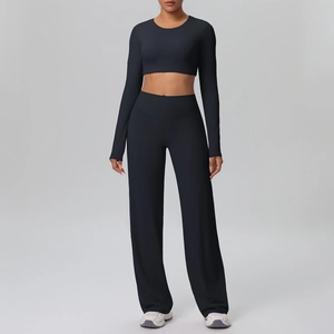 Close-up of black long sleeve crop top and high-waisted wide-leg yoga pants detail