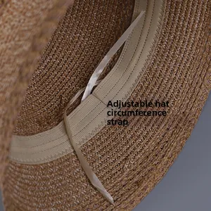 Detailed macro view of the adjustable drawstring inside the woven straw sun hat